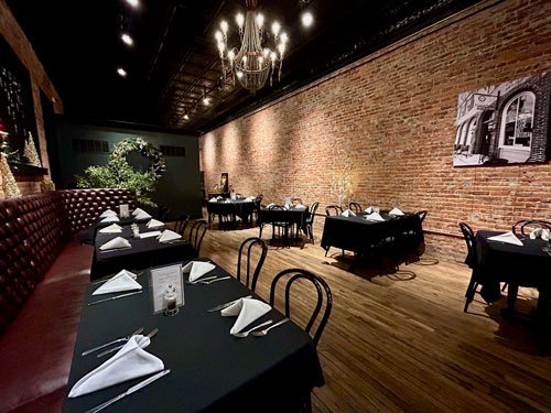 Exposed brick and tall windows in the main dining room
