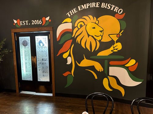 Empire lion mural and kitchen doors inside the bistro